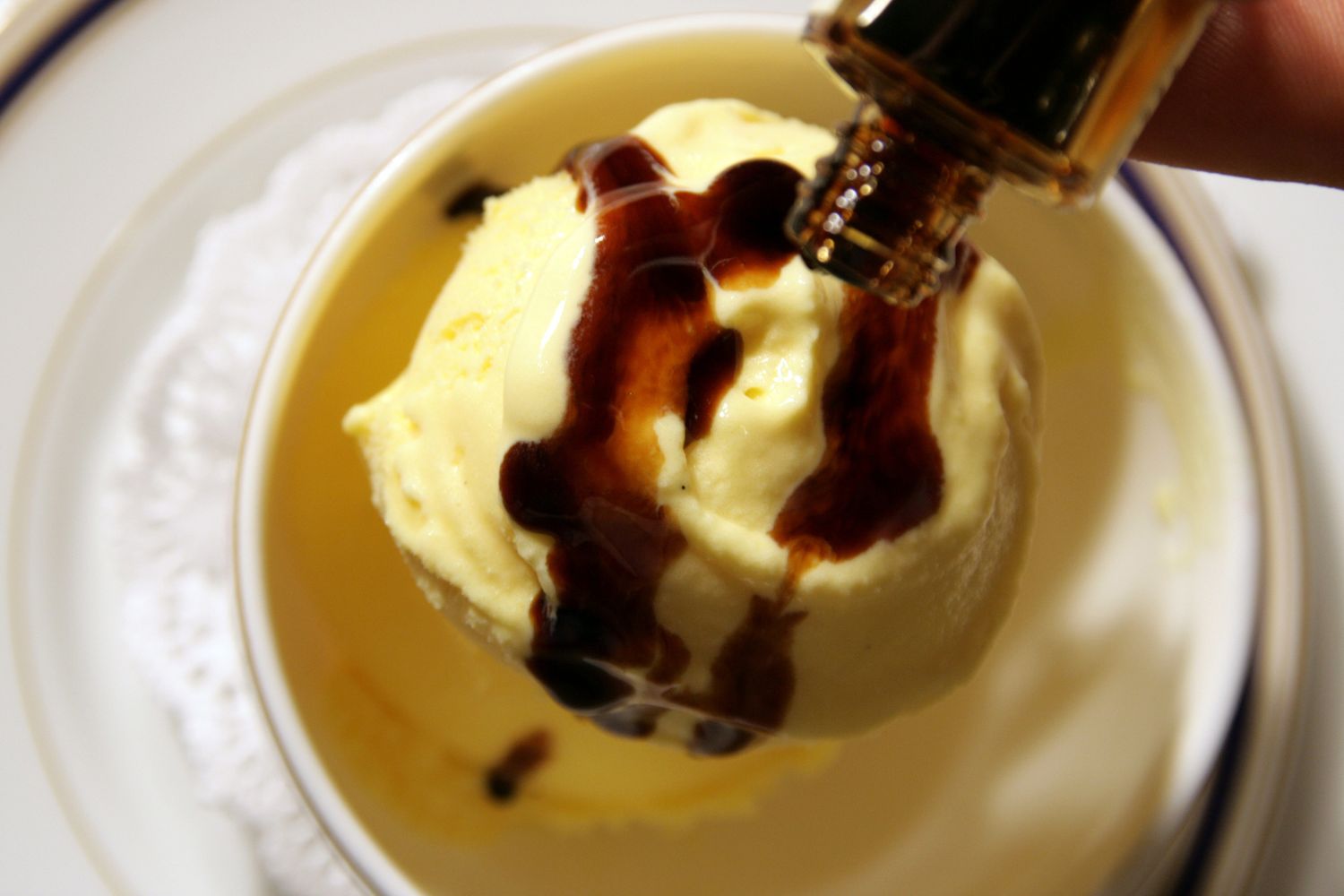 Vanilla ice cream topped with drizzled balsamic vinegar