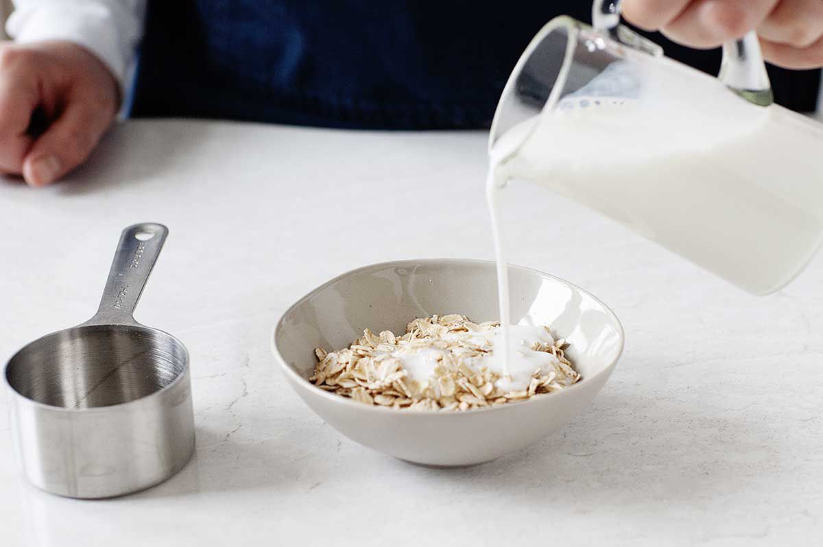 Buttermilk poured over oats to make easy overnight oasts.