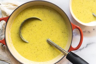 Yellow creamy soup in a red Dutch oven