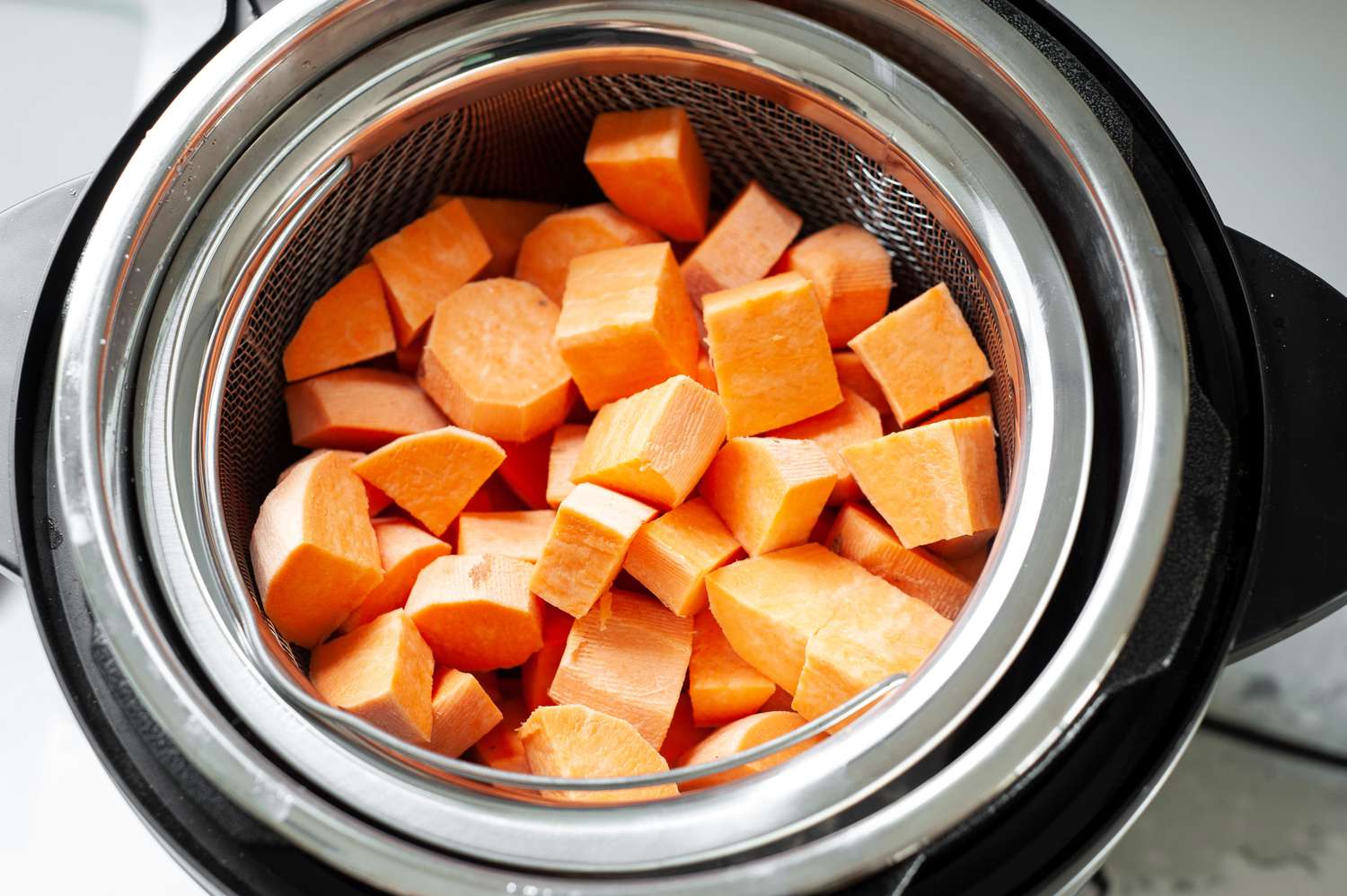 Sweet Potato Cubes in Instant Pot Steamer Basket for Mashed Sweet Potatoes Recipe