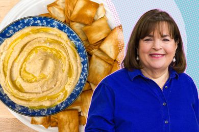 Ina Garten next to a bowl of hummus and pita chips.