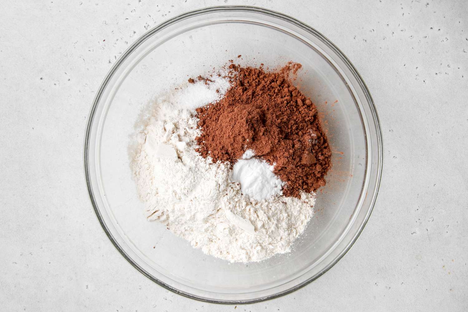 Dry ingredients in a glass bowl to make easy chocolate chocolate cookies.