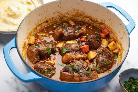 A Dutch oven full of oxtail stew on a counter
