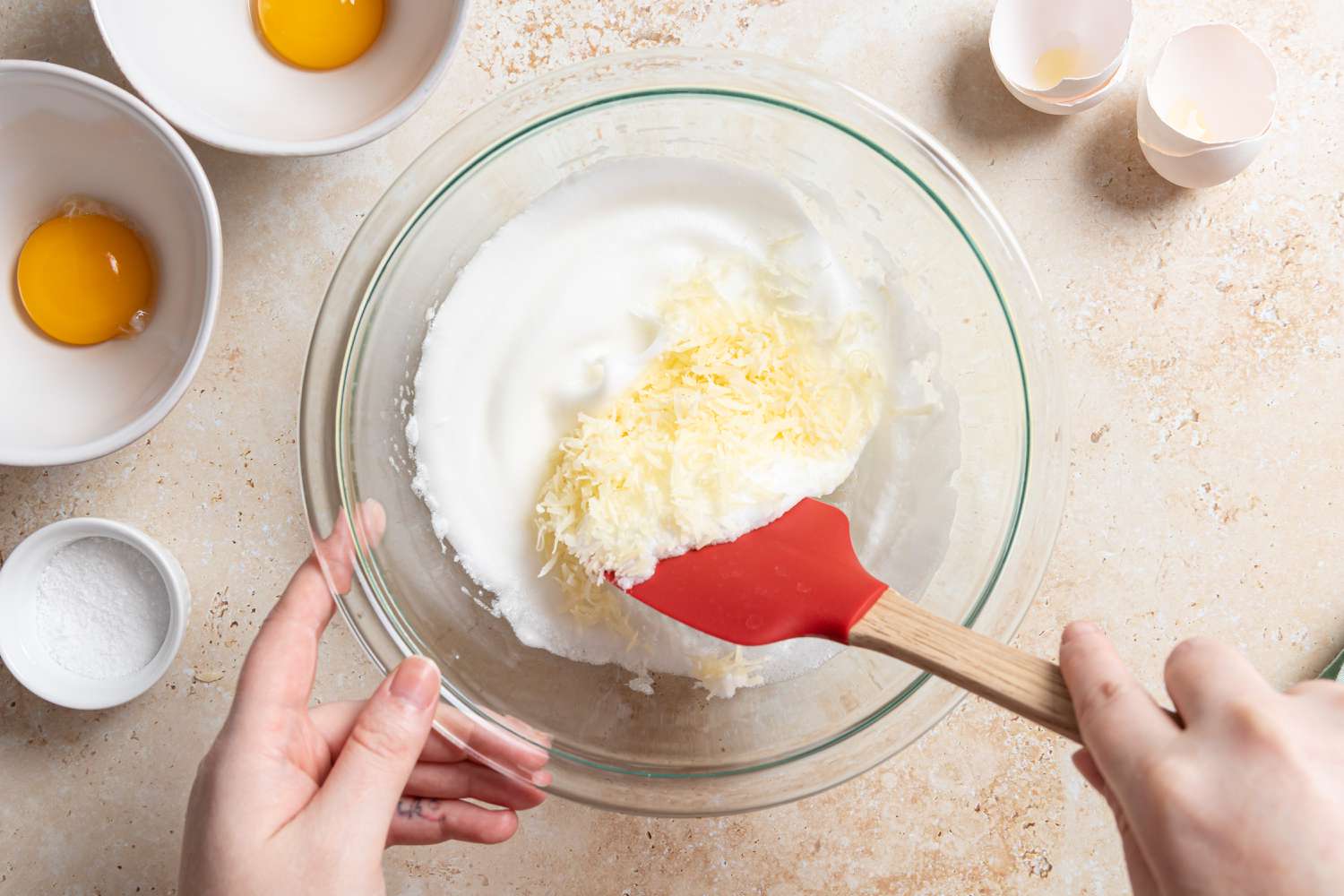 Folding grated cheese into whipped egg whites to make Cloud Eggs