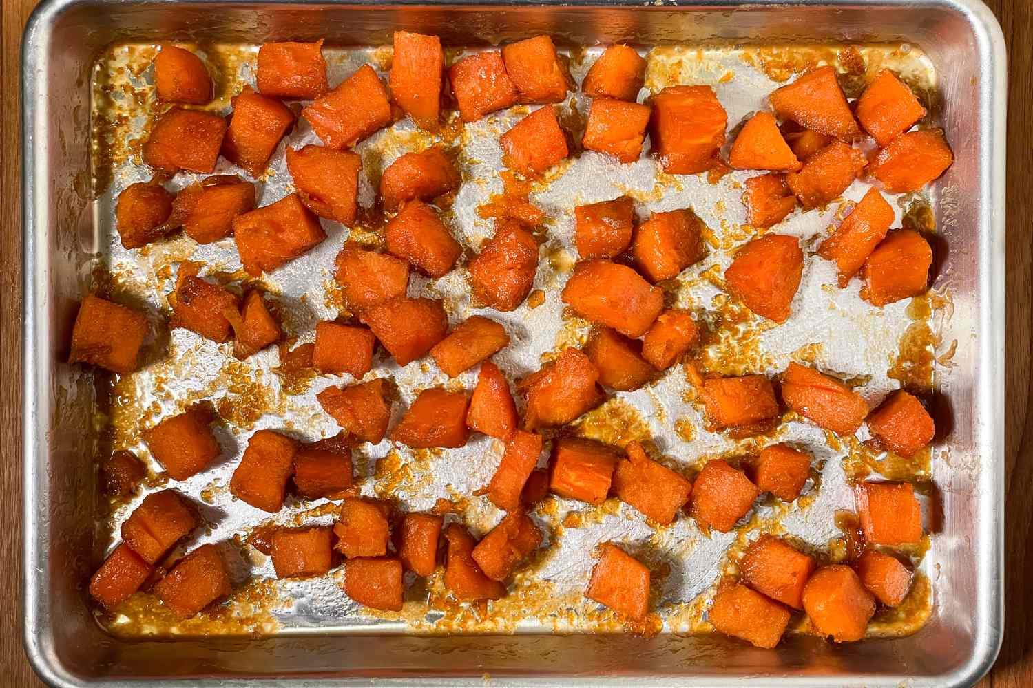 Cubed roasted sweet potatoes on a baking sheet
