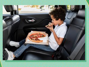 Kid eating a pizza in car