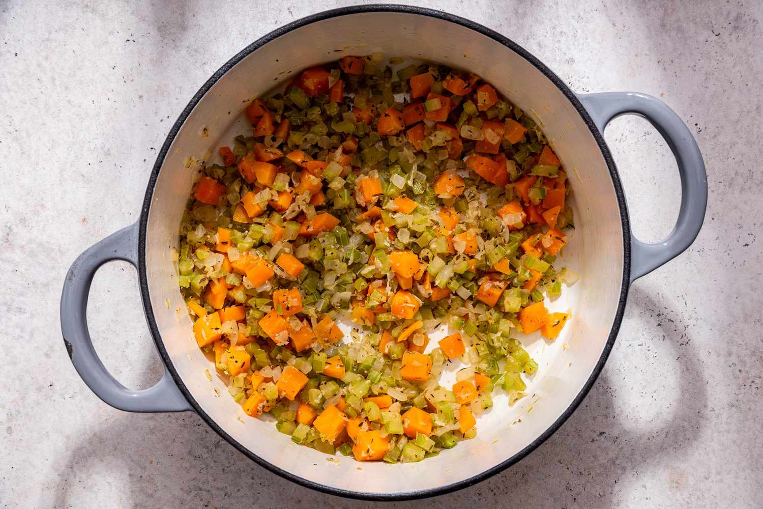 Cooked and seasoned stock vegetables in a Dutch oven for creamy vegetable dumpling soup recipe