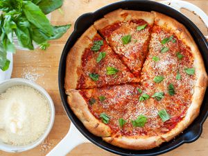 Cast iron pizza with parmesan and basil.