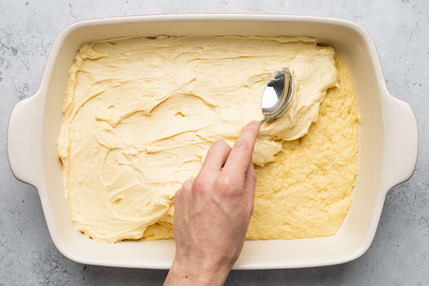 Butter Topping Smeared on Gooey Butter Cake Batter Using a Spoon