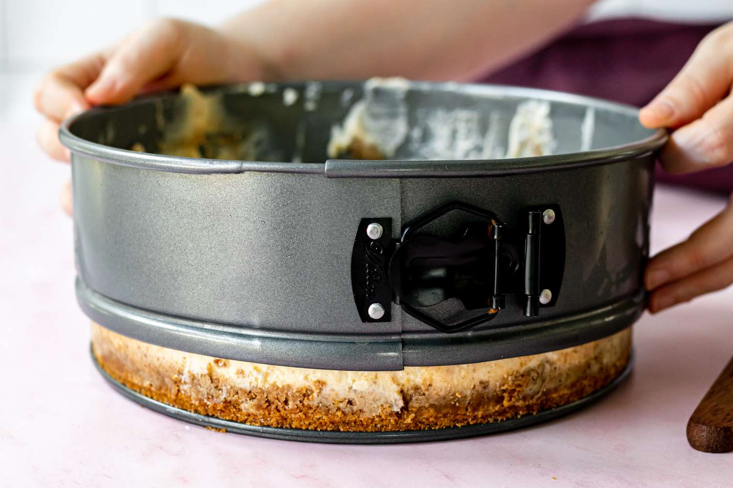 Releasing the cheesecake from the pan.