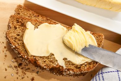home baked irish wheaten bread with butter and knife8BIM