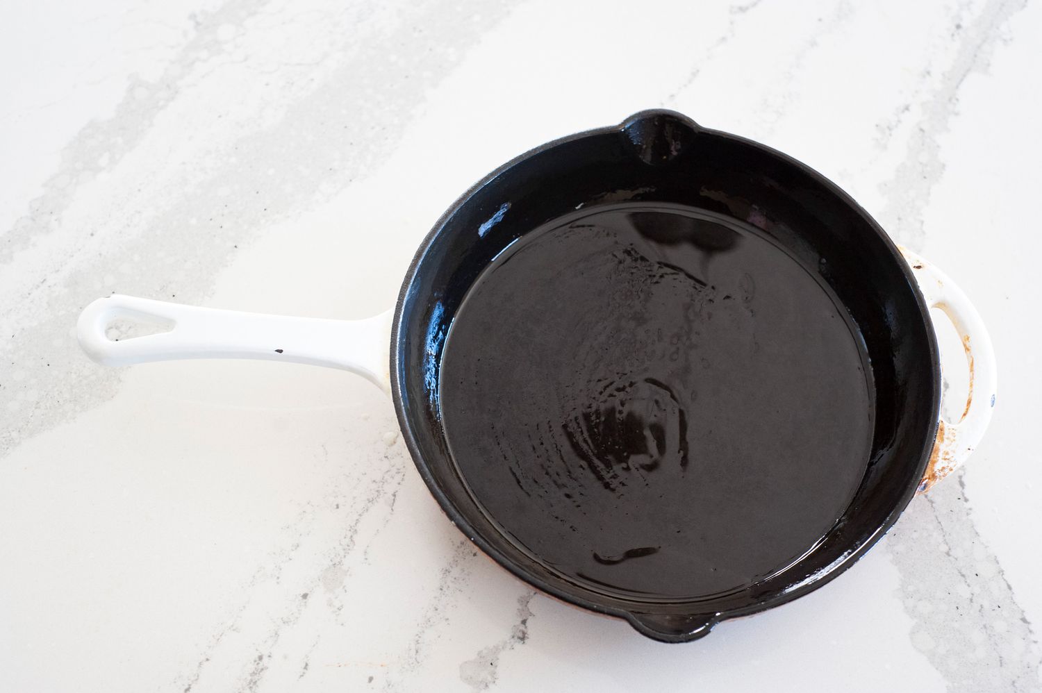 Cast iron skillet coated with oil.