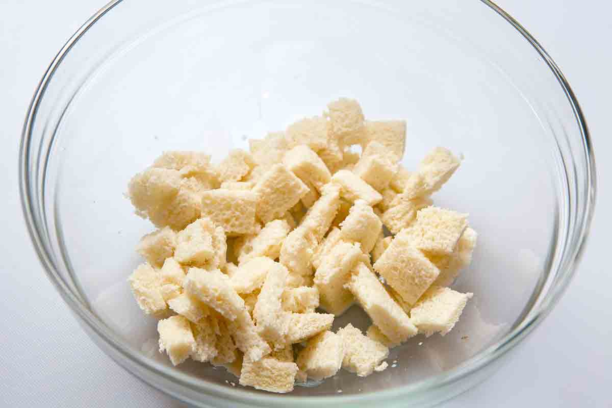 Cubed bread for Swedish meatballs resting in a glass bowl