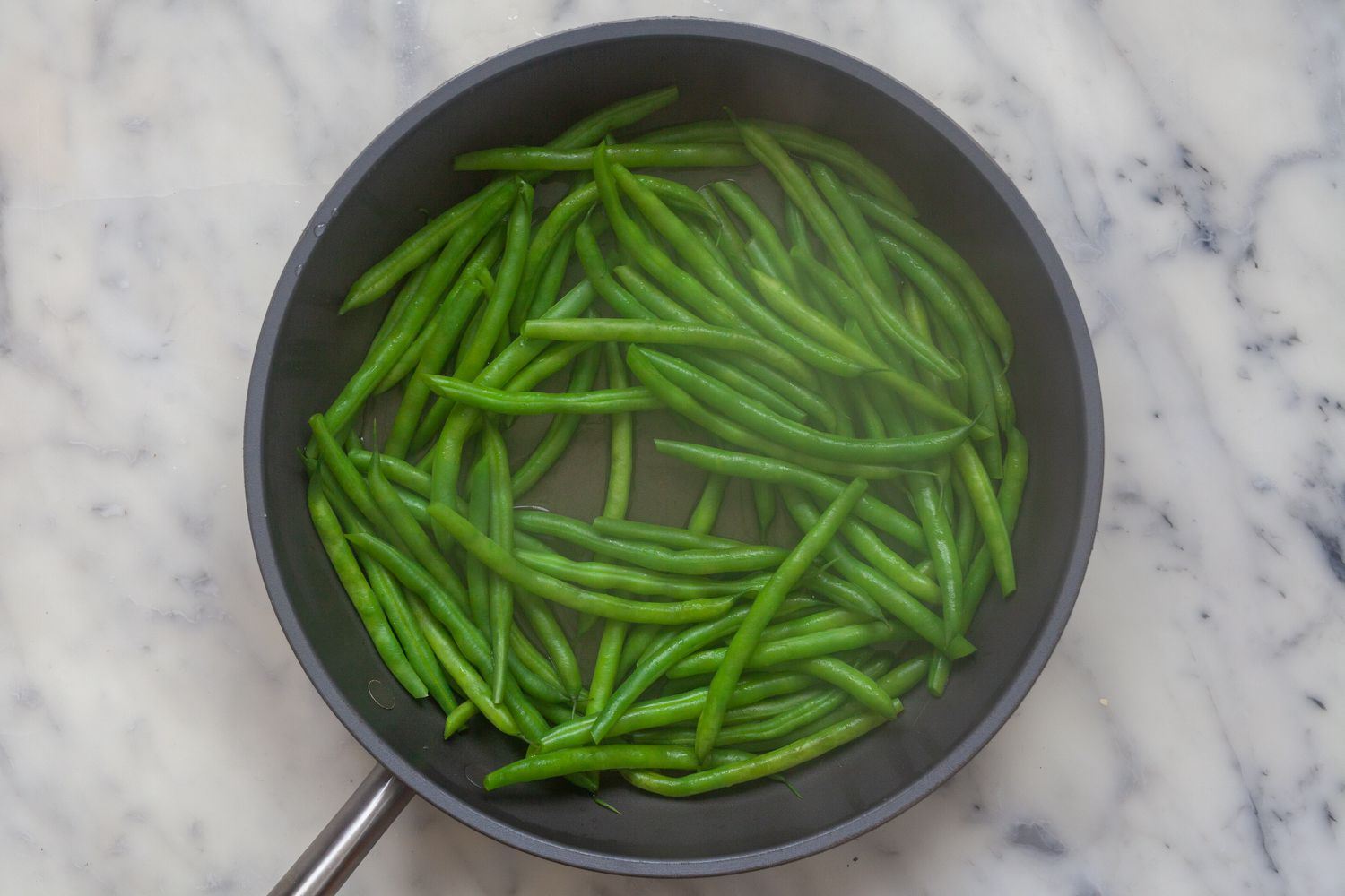 Green beans cooked in a skillet to make Blistered Green Beans with Gochujang.