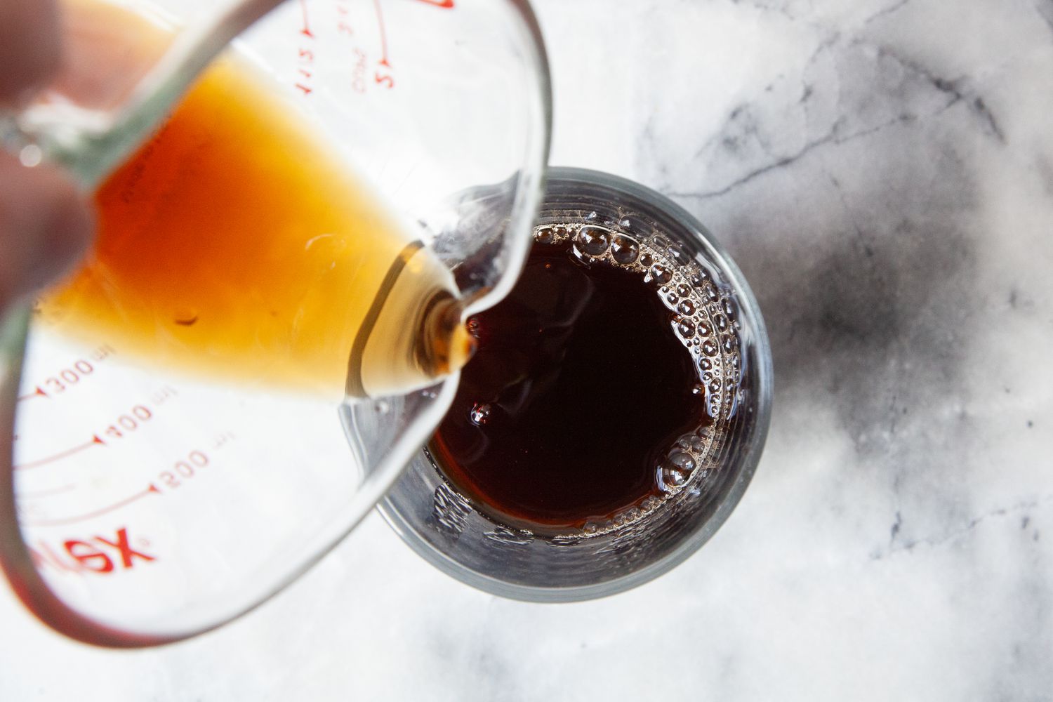 Black Tea Added to Glass With Tapioca Pearls