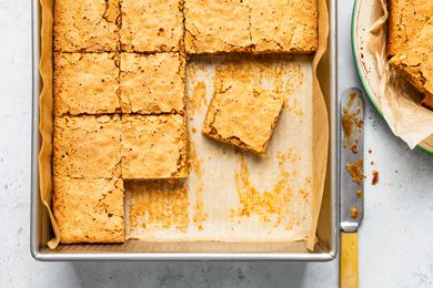 Sad cake on a parchment paper-lined baking pan