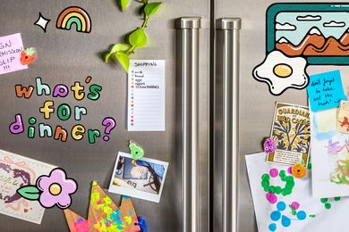 Refrigerator with decorations and notes including a shopping list and childrens artwork