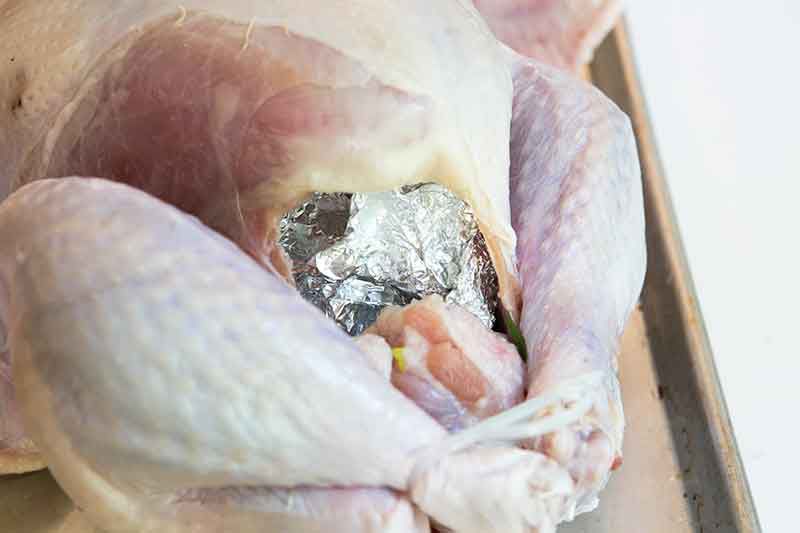 Foil covered aromatics for a turkey recipe.