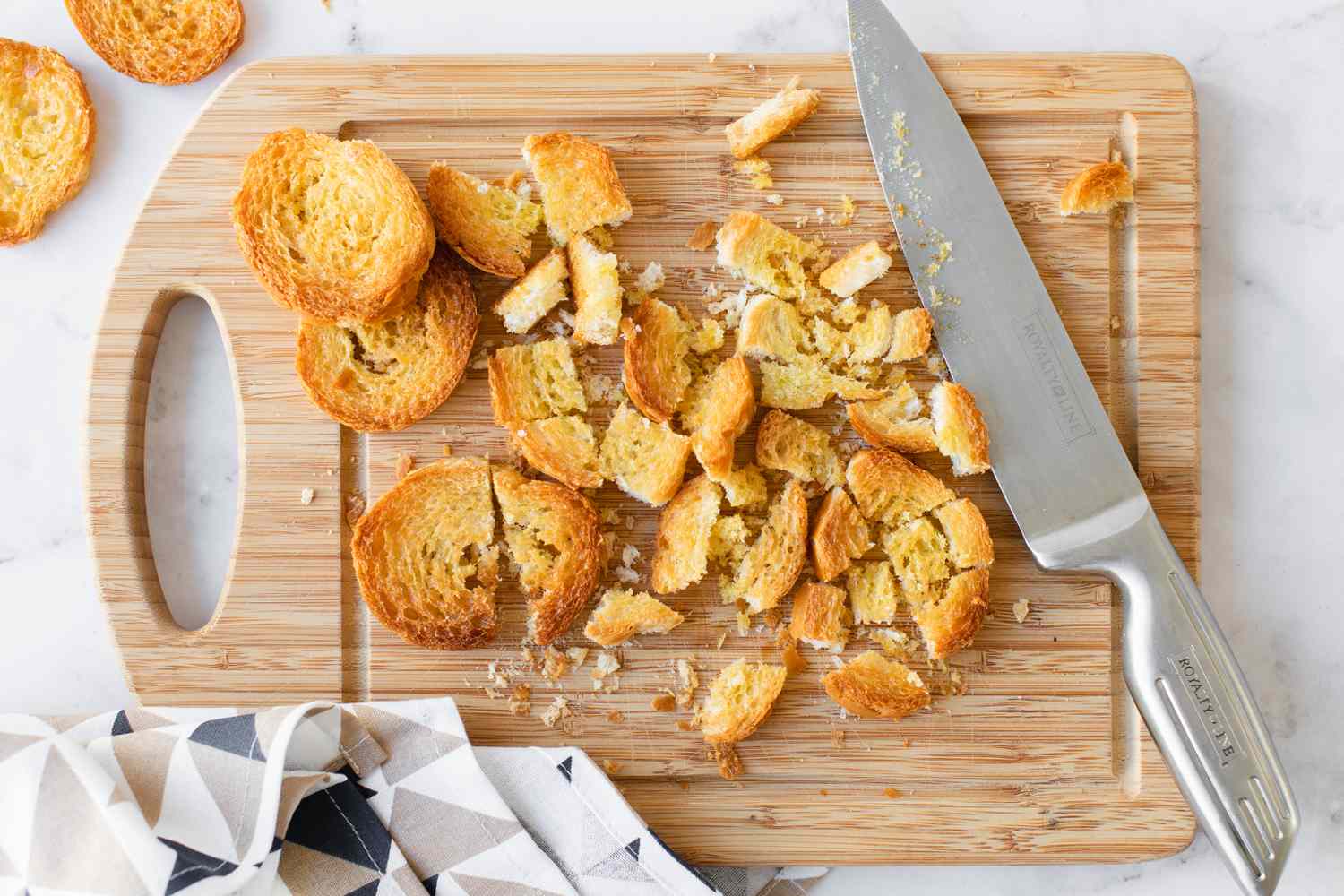 Toasted Bread Roughly Cut into Croutons on a Cutting Board for Classic Caesar Salad