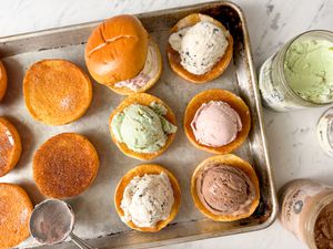 Brioche buns with scoops of ice cream served on a tray
