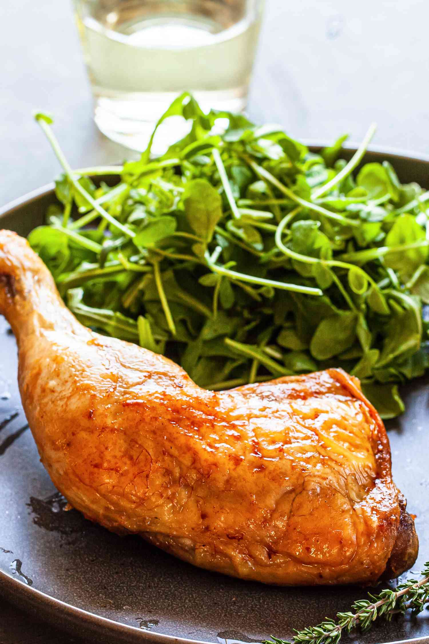 One chicken confit with a side of greens.