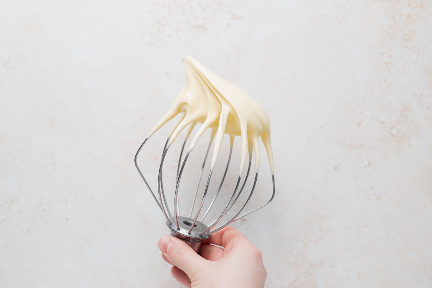 Lemon meringue on a whisk to make Lemon buttercream macarons.