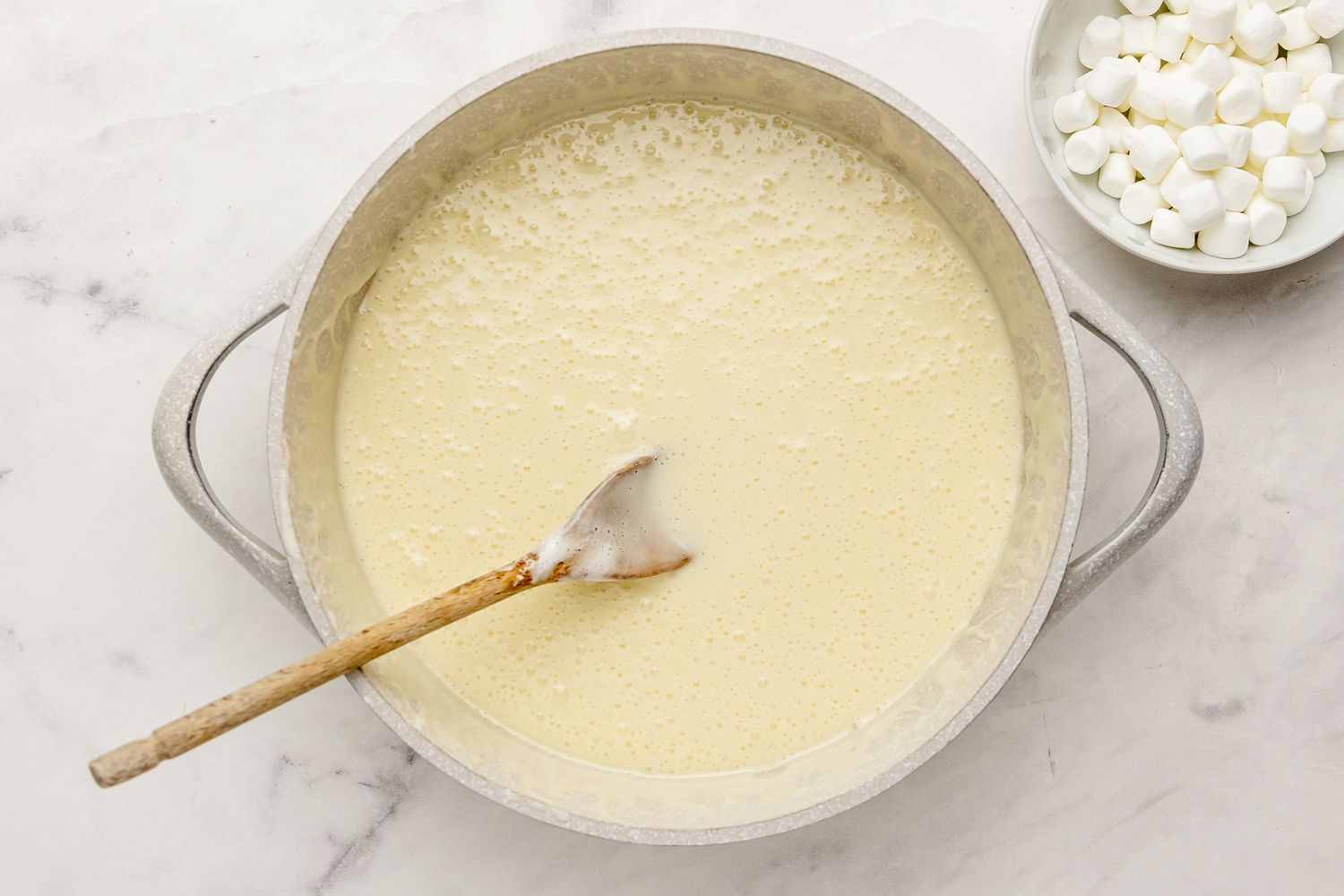Pot of Melted Butter and Marshmallows for S’mores Cereal Bars Next to Smaller Bowl of Marshmallows