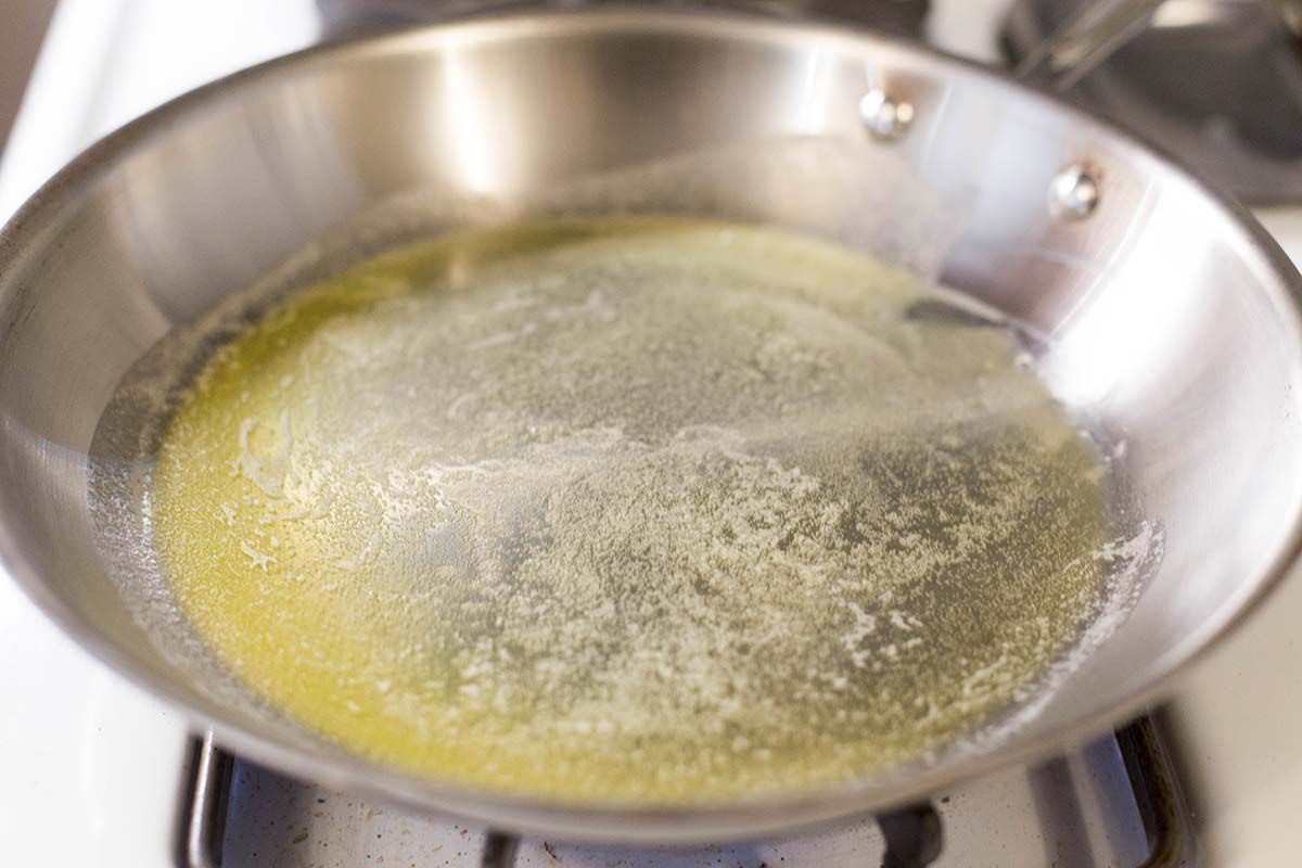 melting butter for Scrambled Eggs with Spinach, Beef, and Mushrooms