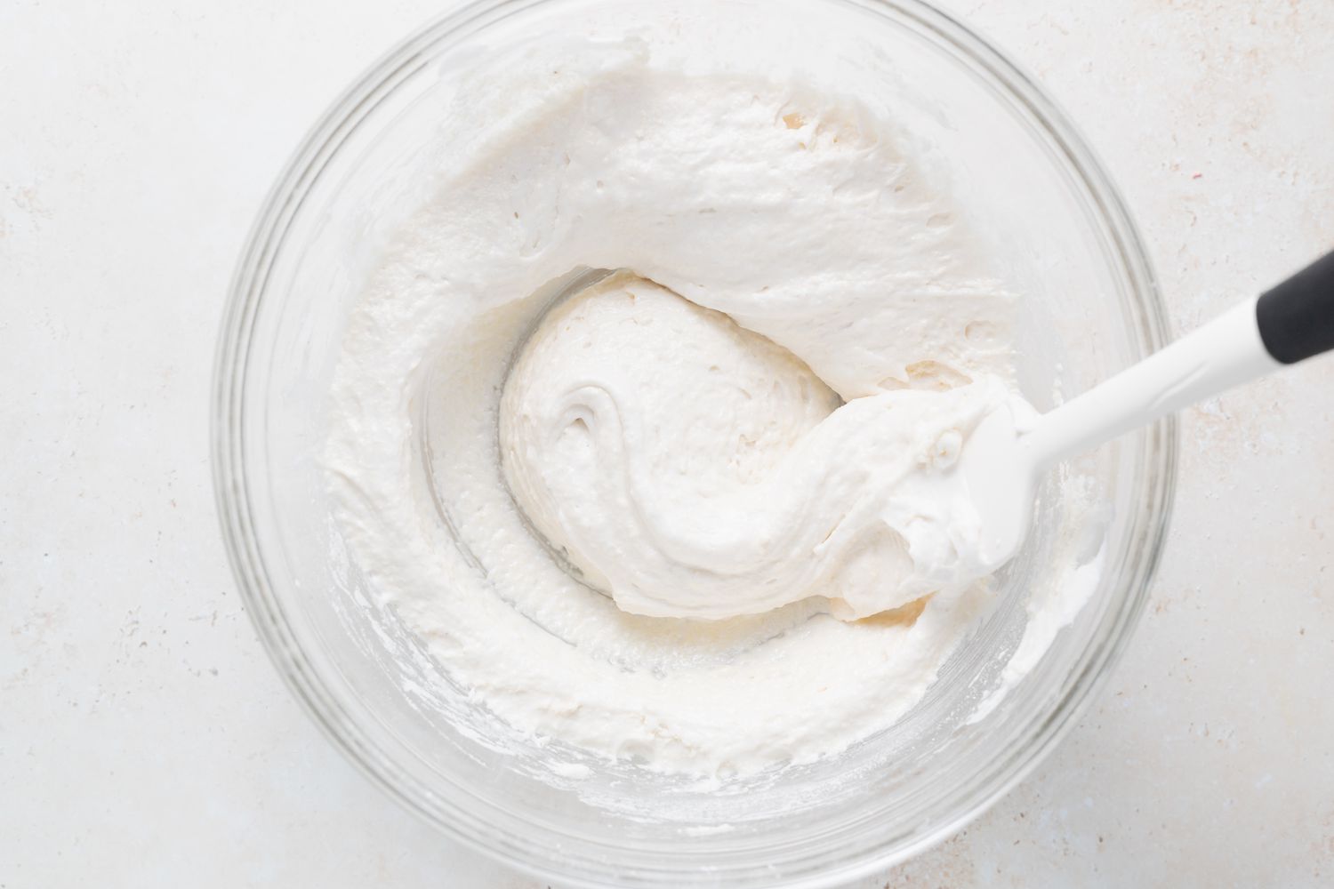 Folding in dry ingredients to egg white mixture to make french macarons.