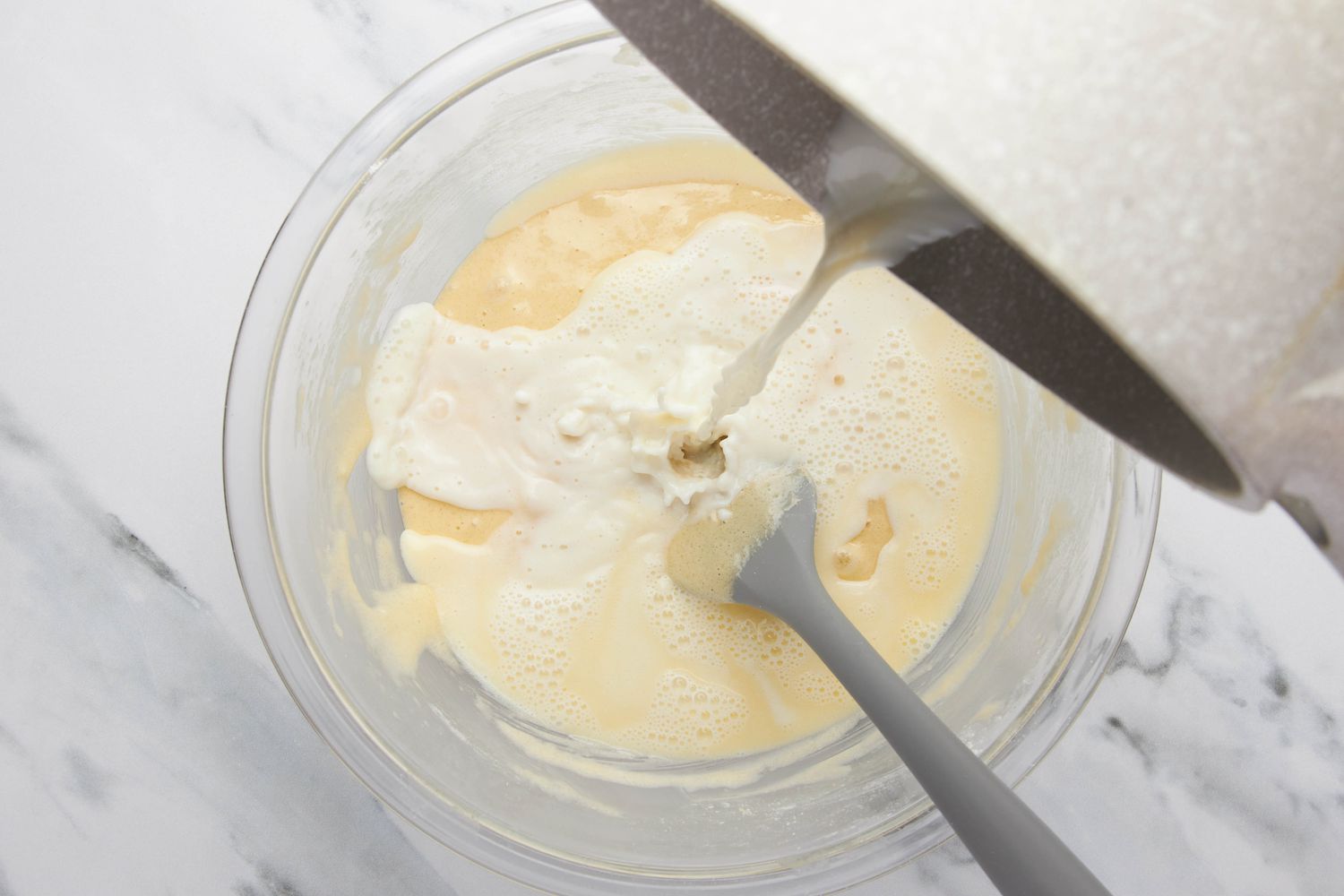 Milk and butter mixture poured into the bowl with the rest of the lazy daisy cake ingredients
