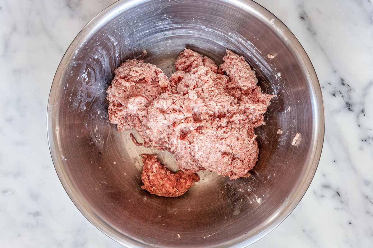 Ground beef and pork sausage meatball recipe - beef and pork sausage in silver bowl