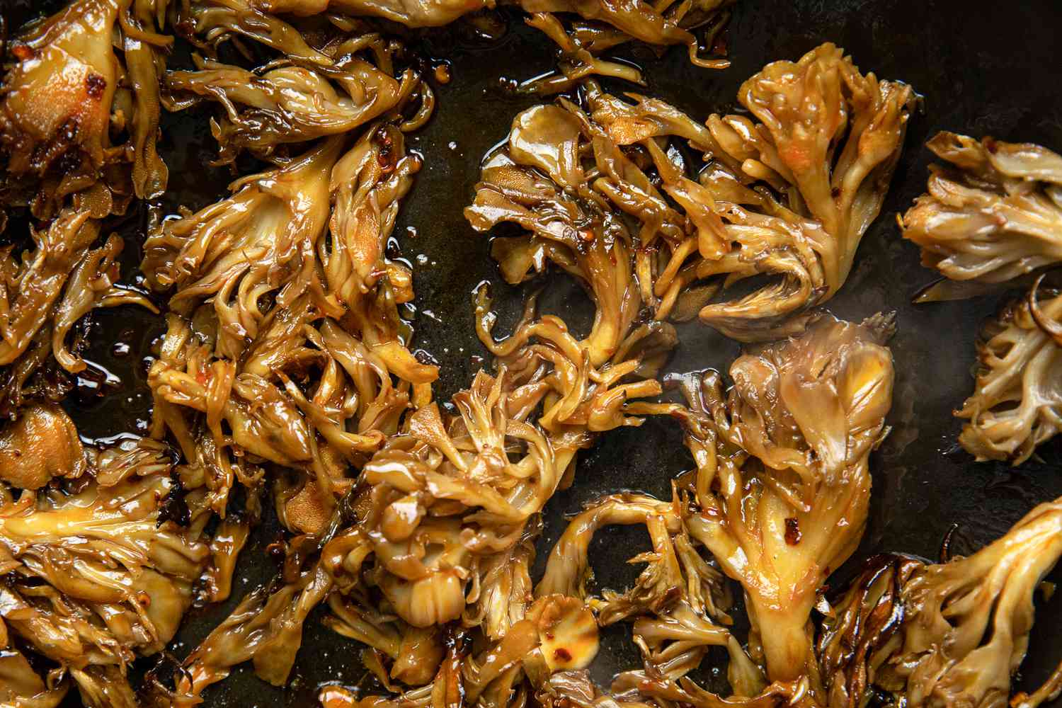 Chili Oil and Sliced Garlic Added to Stir-Fried Maitake Mushrooms with Garlic and Chile Oil
