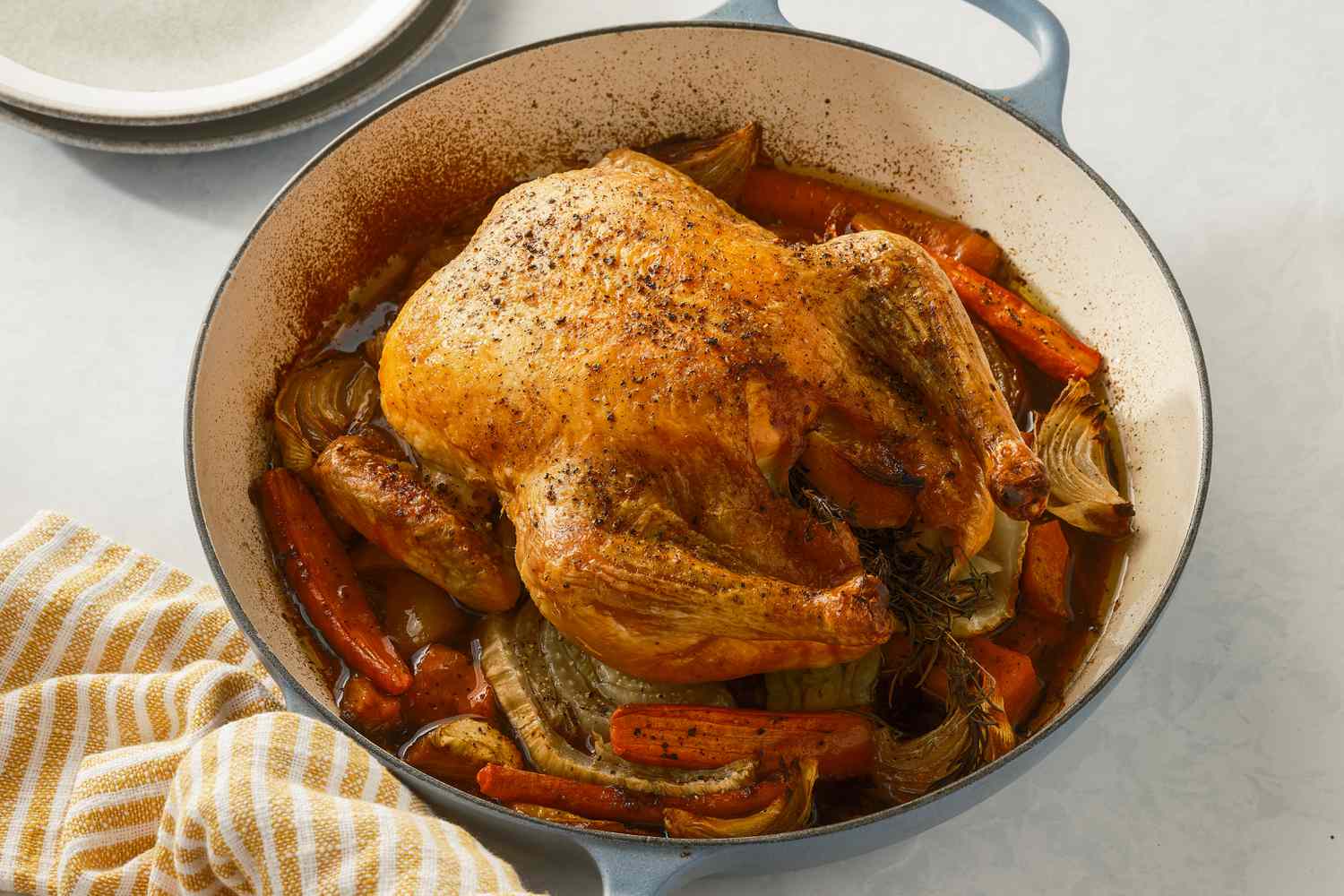 Roasted chicken over vegetable in a braiser