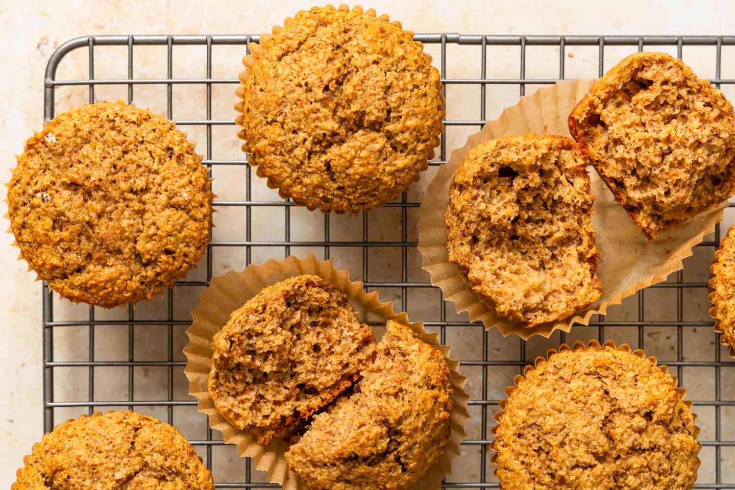 Bran muffins on a cooling rack (some of the muffins broken in half)
