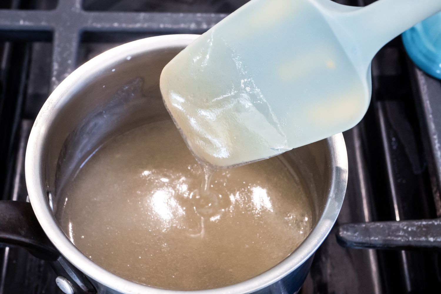 Spatula Lifting Some Agar-Agar Mixture from a Pot to Show Consistency for Marshmallows Recipe Vegan