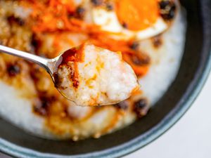 Spoon of jook with toppings