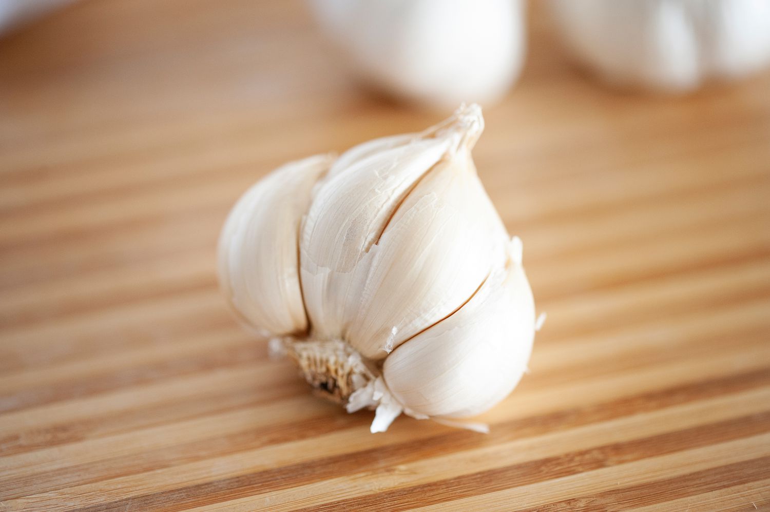 Fresh garlic on a wooden background.