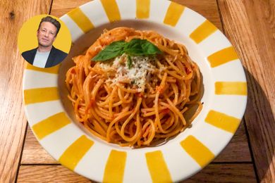 Jamie Oliver with a plate of spaghetti in arrabbiata sauce