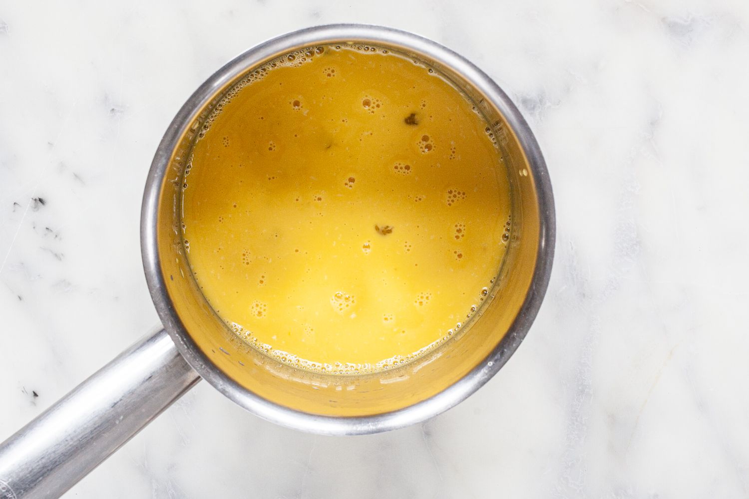 Stovetop Hollandaise Sauce in a saucepan.