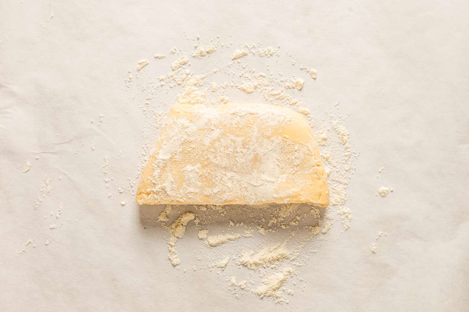 Overhead view of half of the dough after chilling and covered in flour ready to roll from Sand Tarts recipe