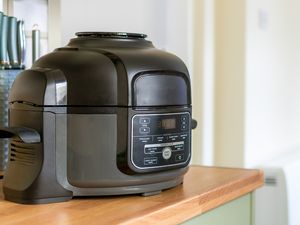 Kitchen countertop with an air fryer in the foreground