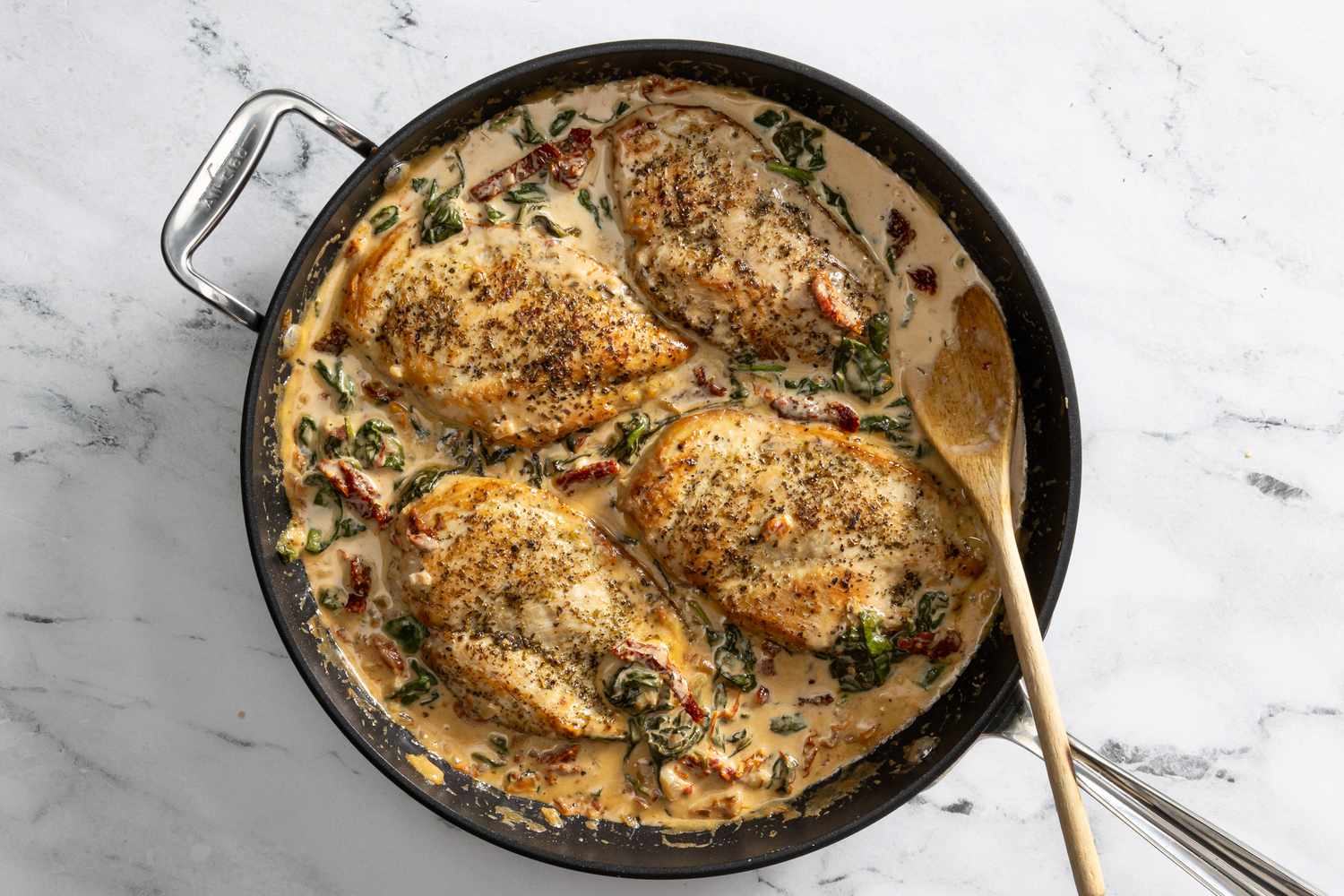 creamy tuscan chicken in a skillet 