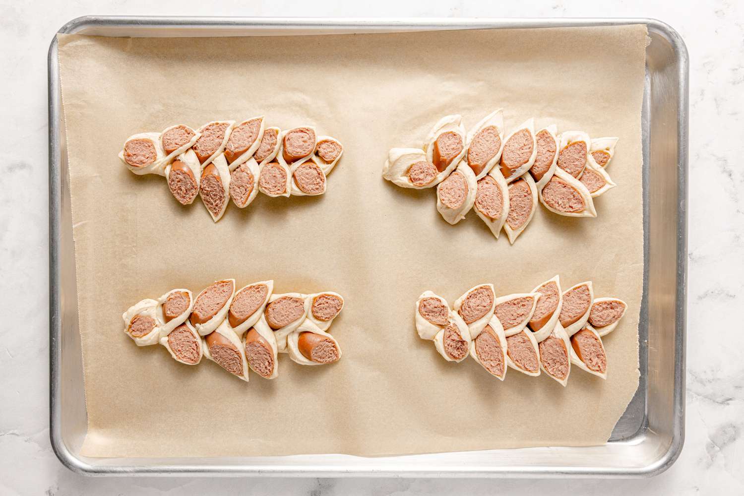 Korean Sausage Bread (Uncooked) on a Lined Baking Sheet