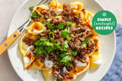 A plate of pasta shells topped with ground meat and garnished with parsley with the label Simply Recipes Weeknight visible