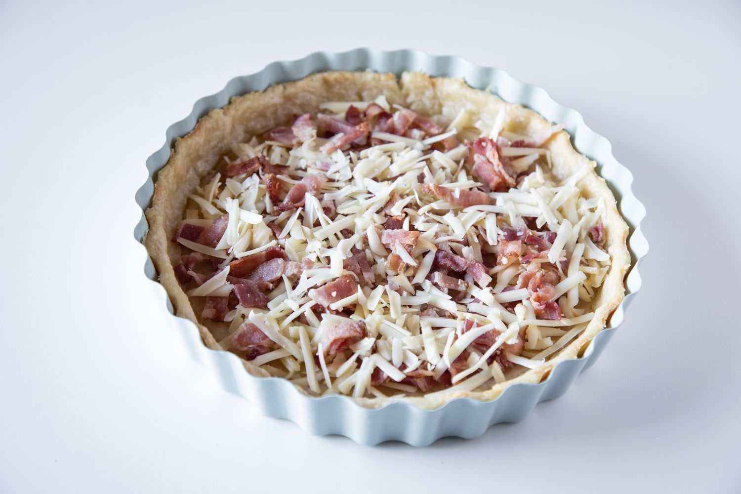 An easy quiche recipe with bacon and cheese added to the crust.