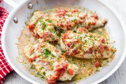 Cheesy Bruschetta Chicken Cutlets in a Stainless Steel Skillet