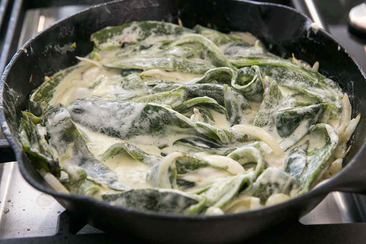 add cream and cheese to the roasted poblanos for the best rajas con crema