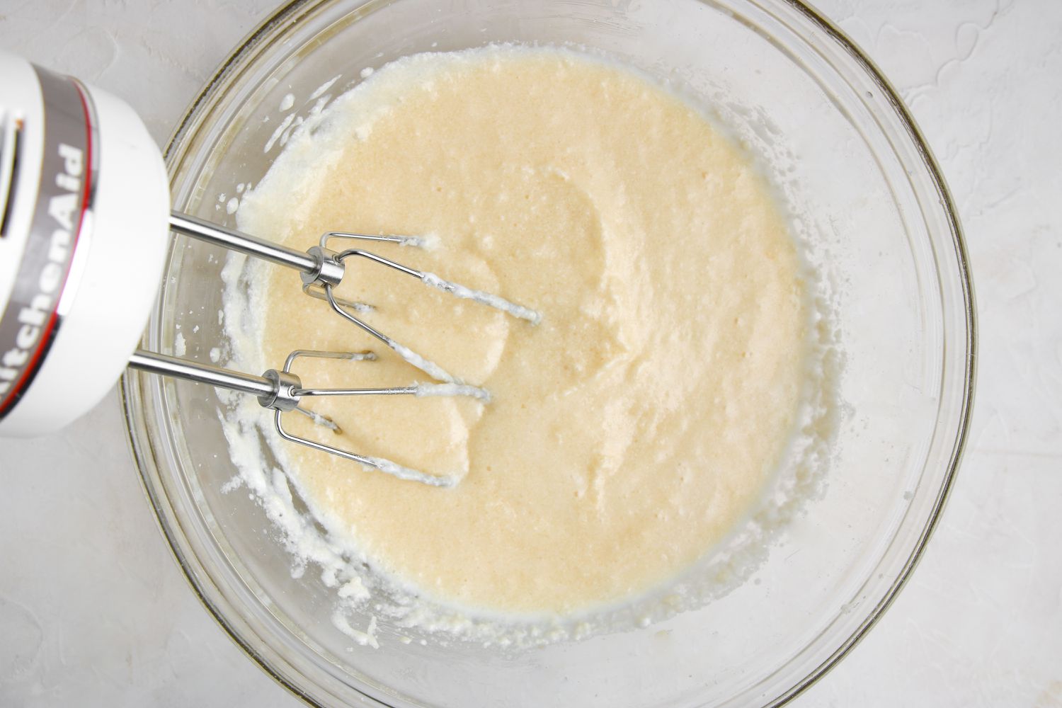Using a hand mixer to make the batter for apple bread with streusel.