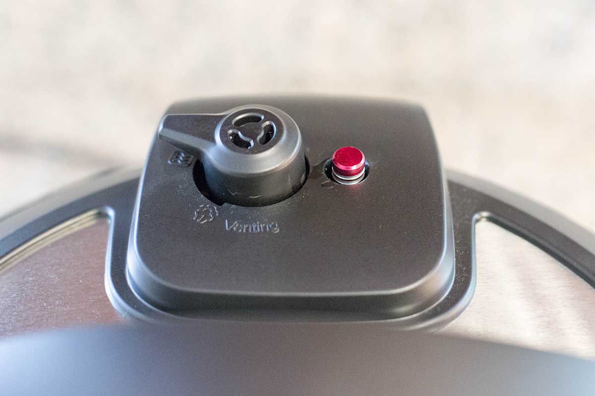 Up close view of venting knob in the sealed position to make instant pot chicken noodle soup.