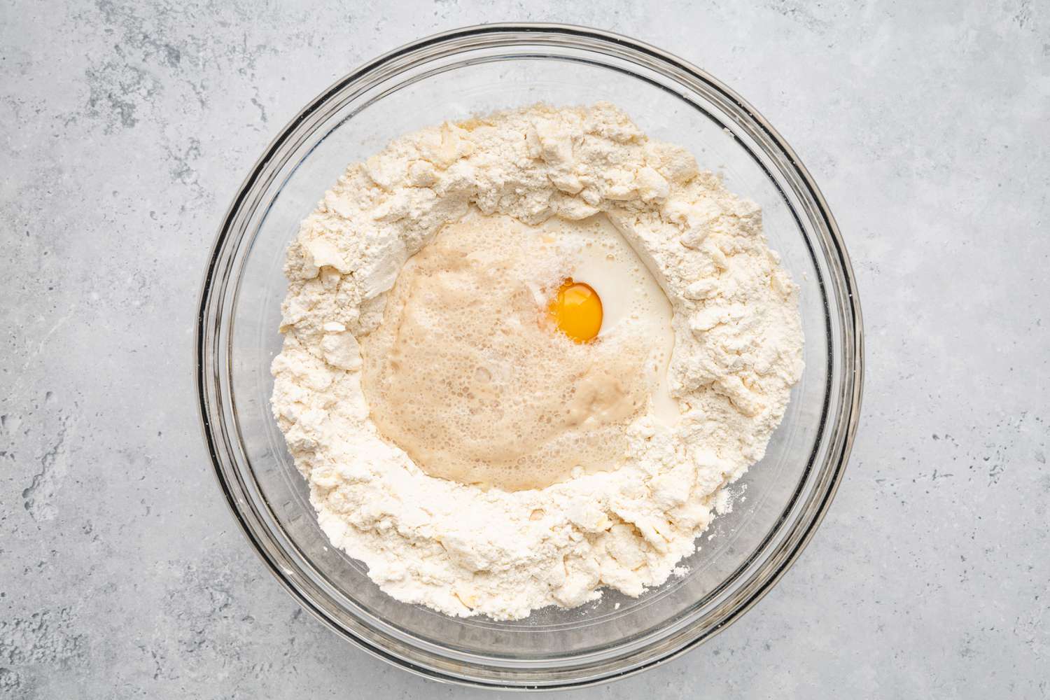 Yeast, Milk, and Eggs Added to Crescent Rolls Flour and Butter Mixture